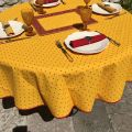 Coated cotton round tablecloth "Calisson" yellow and red by Tissus Toselli