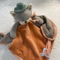 Peluches Bukowski - Doudou et porte tétine ourson "Remi baby rug" orange