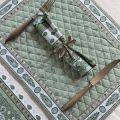 Bordered quilted placemats "Bastide" ecru and green, green background, by Marat d'Avignon