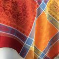 Square Jacquard tablecloth "Vaucluse" red and orange, by Tissus Toselli